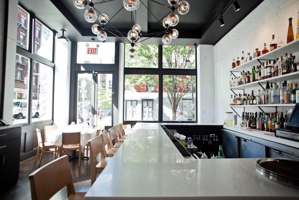 a kitchen with a table in front of a window