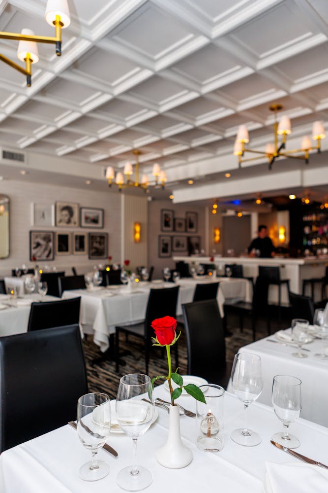 a room filled with furniture and vase of flowers on a table