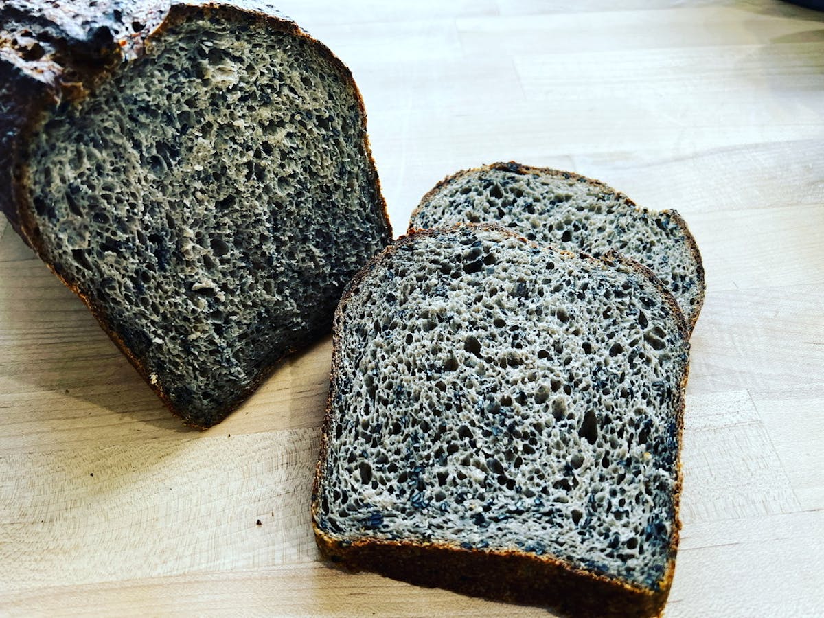 a piece of bread on a cutting board with a cake