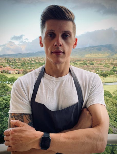 Stromae standing in front of a mountain