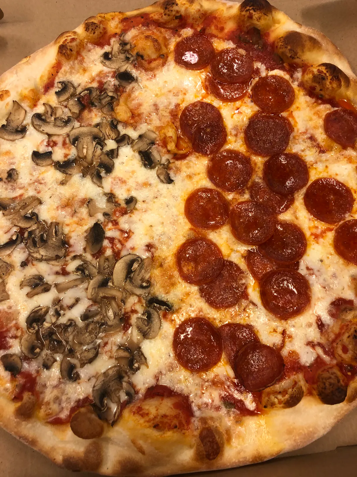 a close up of a pepperoni pizza sitting on top of a pan