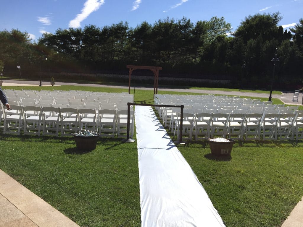 a field full of chairs and a white carpet