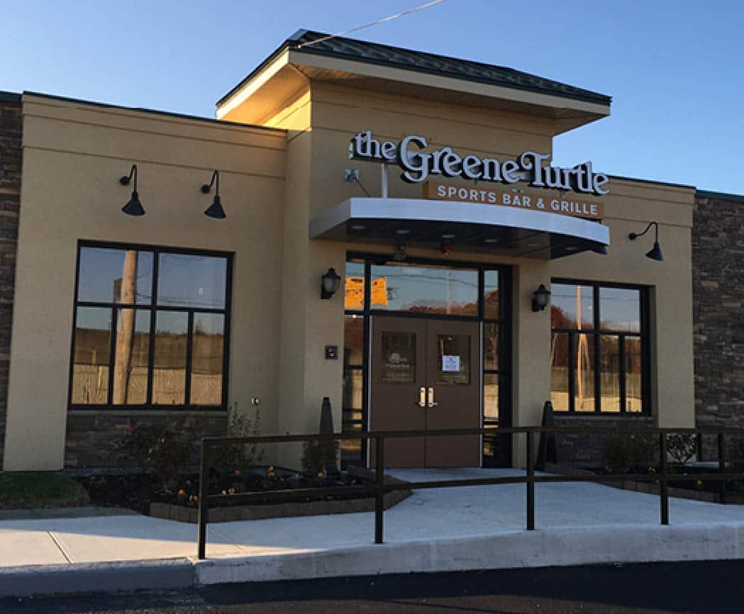 a house that has a sign on the side of a building