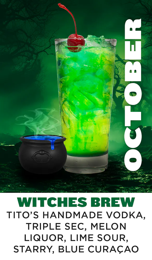 a green drink with a black pot