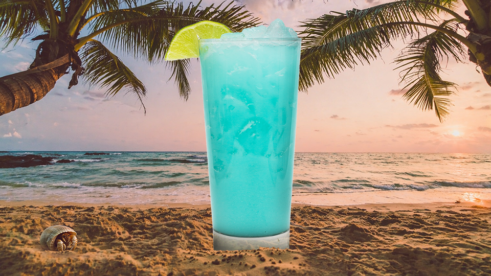 a blue drink on a beach