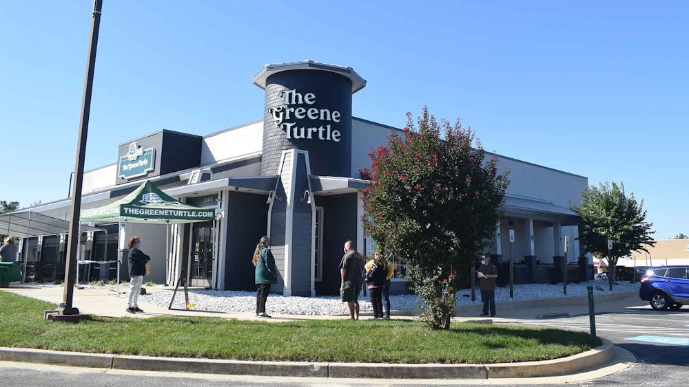 a building that has a sign on the side of a road