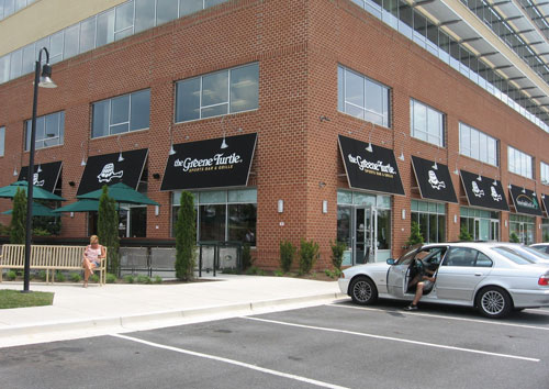 a building with a store on the side of a road