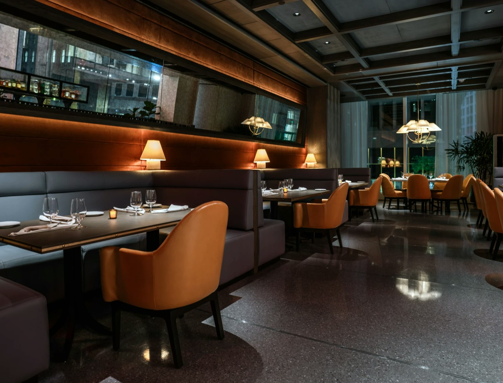 The Vermilion Club main dining room with warm lighting and modern seating.