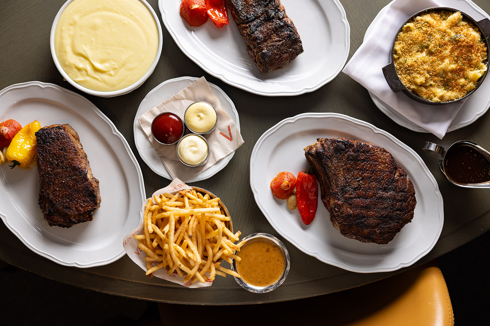 Three steak cuts with multiple sauces and sides, calling for a special wine with steak pairing.