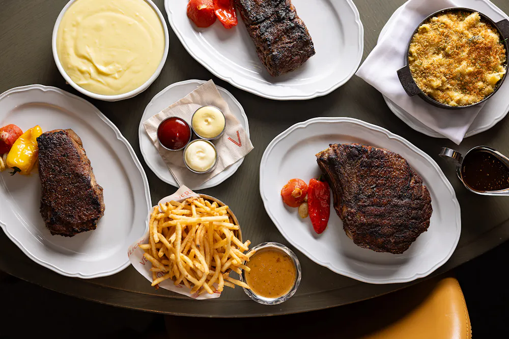 Three steak cuts with multiple sauces and sides, calling for a special wine with steak pairing.