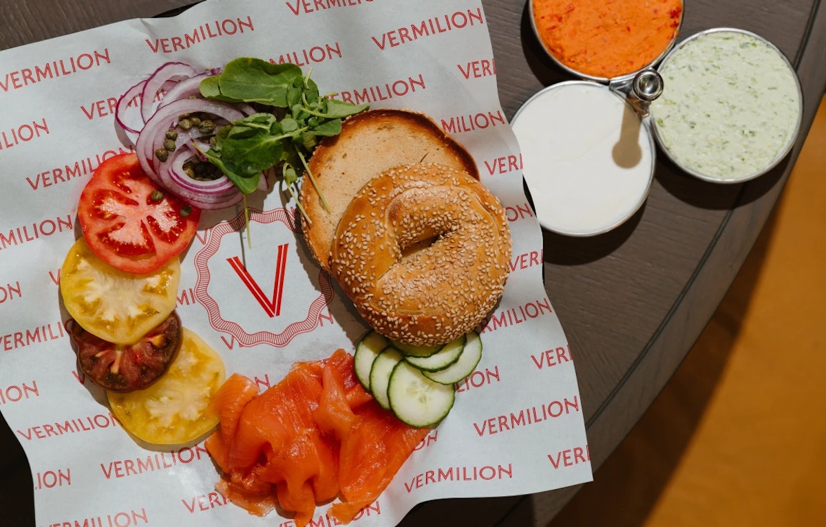 Deconstructed salmon bagel with tomato, lettuce, onion and sauces