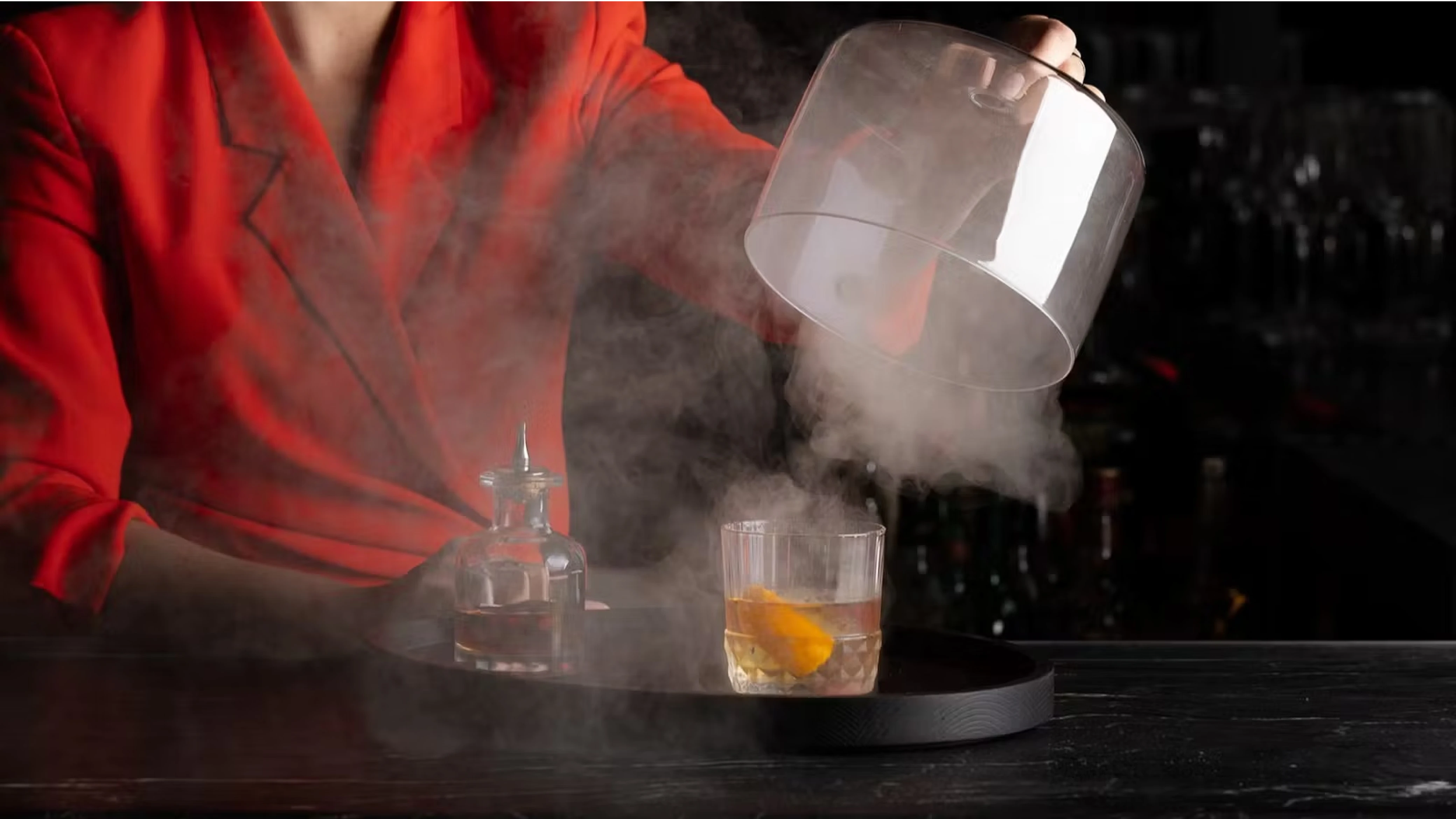 A smoked cocktail being unveiled at The Vermilion Club bar.
