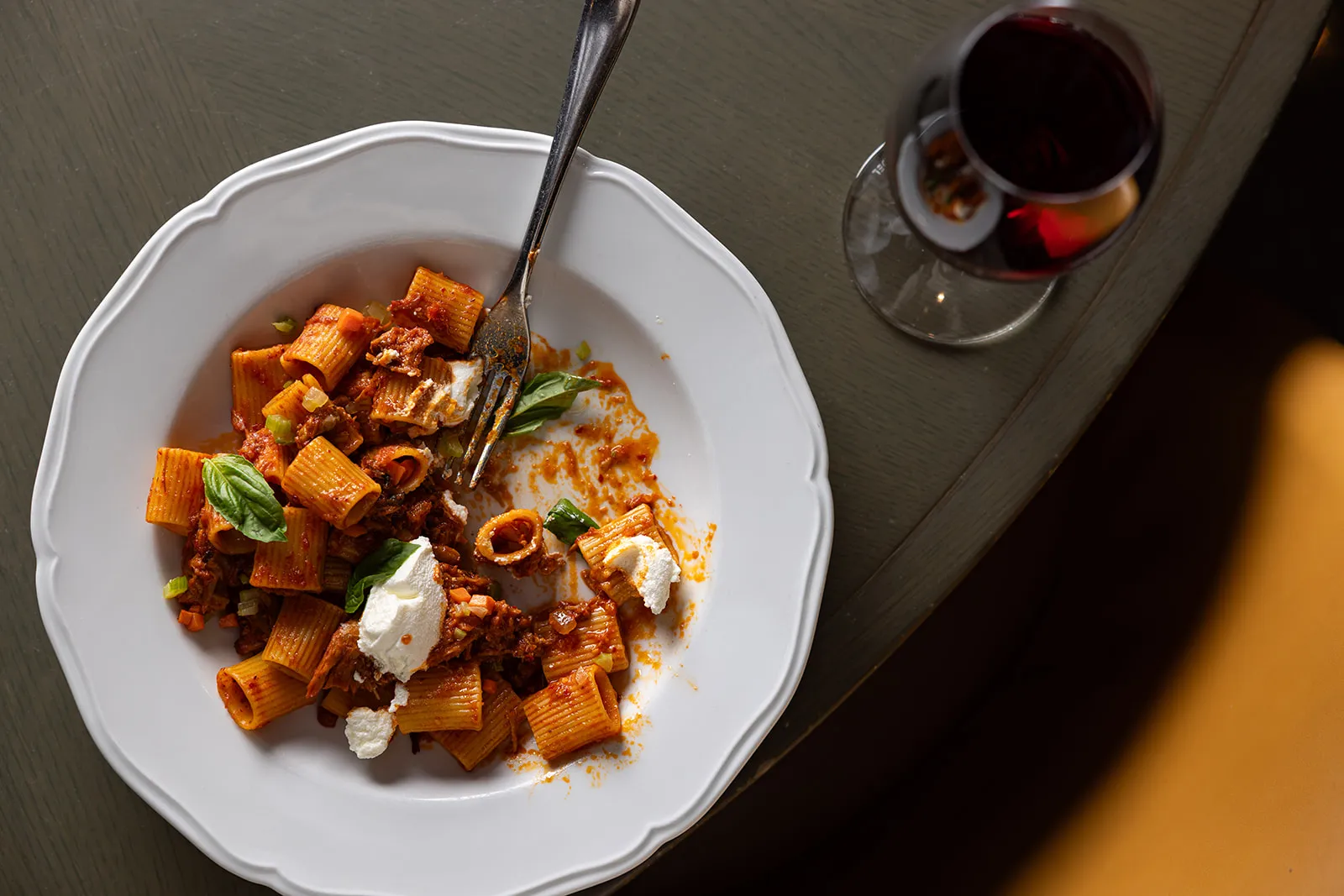 a plate of pasta and a glass of wine