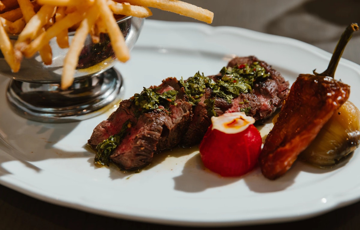 Steak with french fries and baked peppers