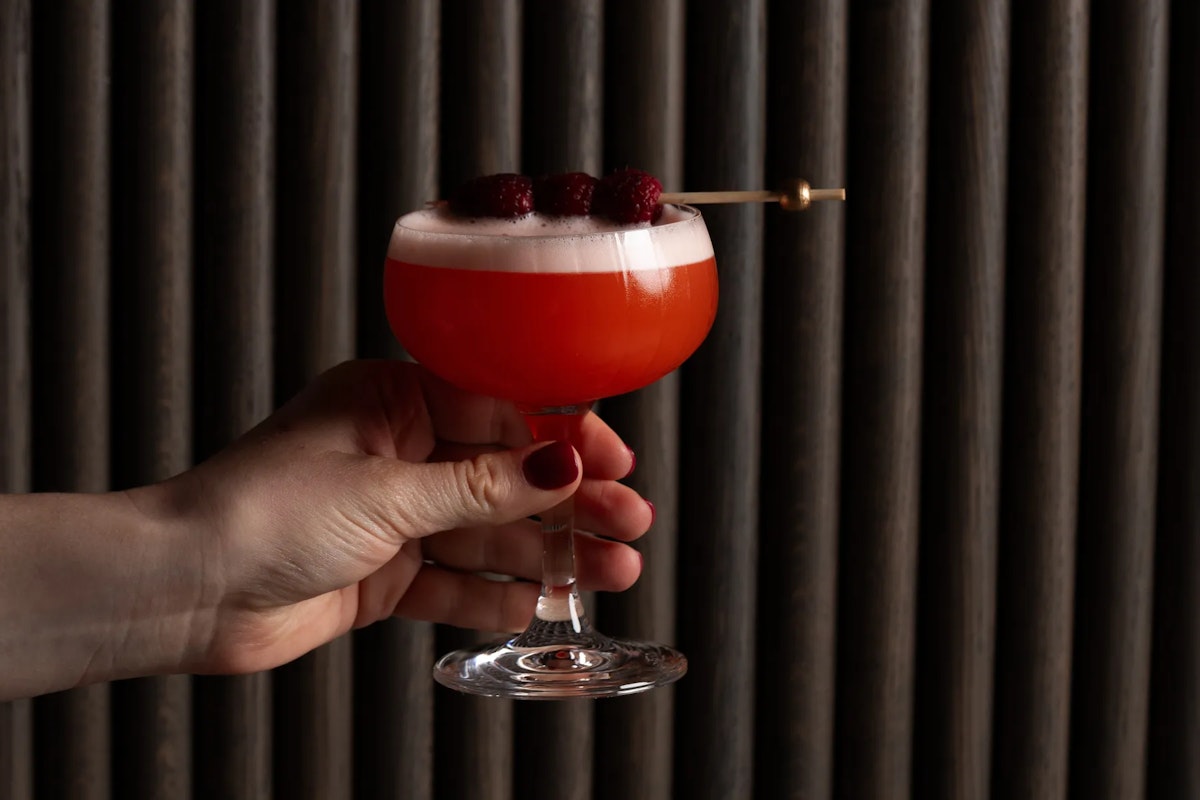 Hand holding clover cocktail