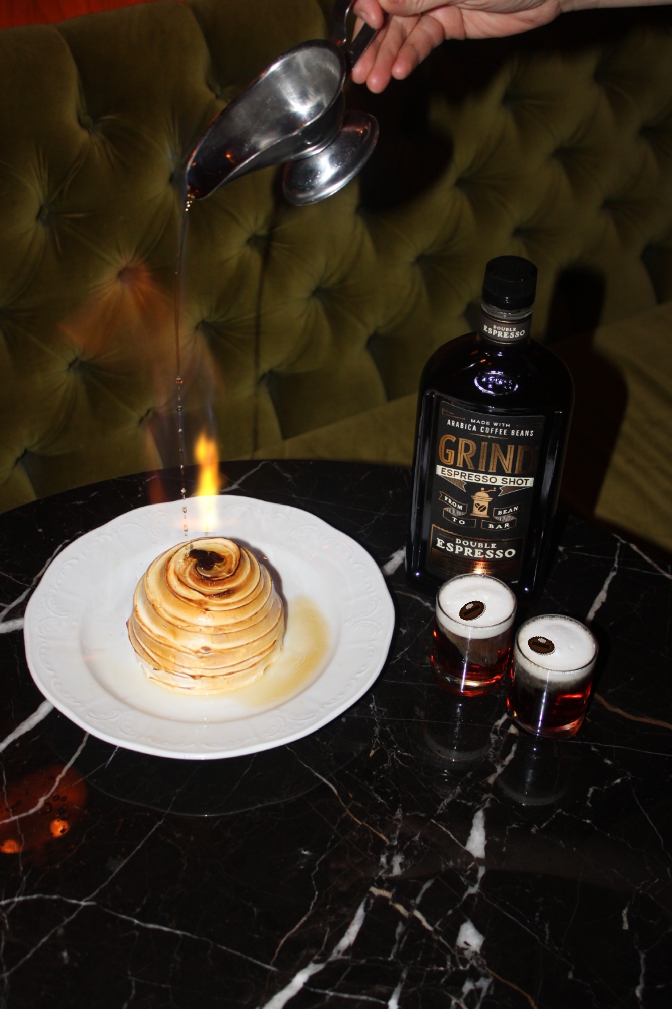 Baked Alaska dessert served alongside espresso martini shots.