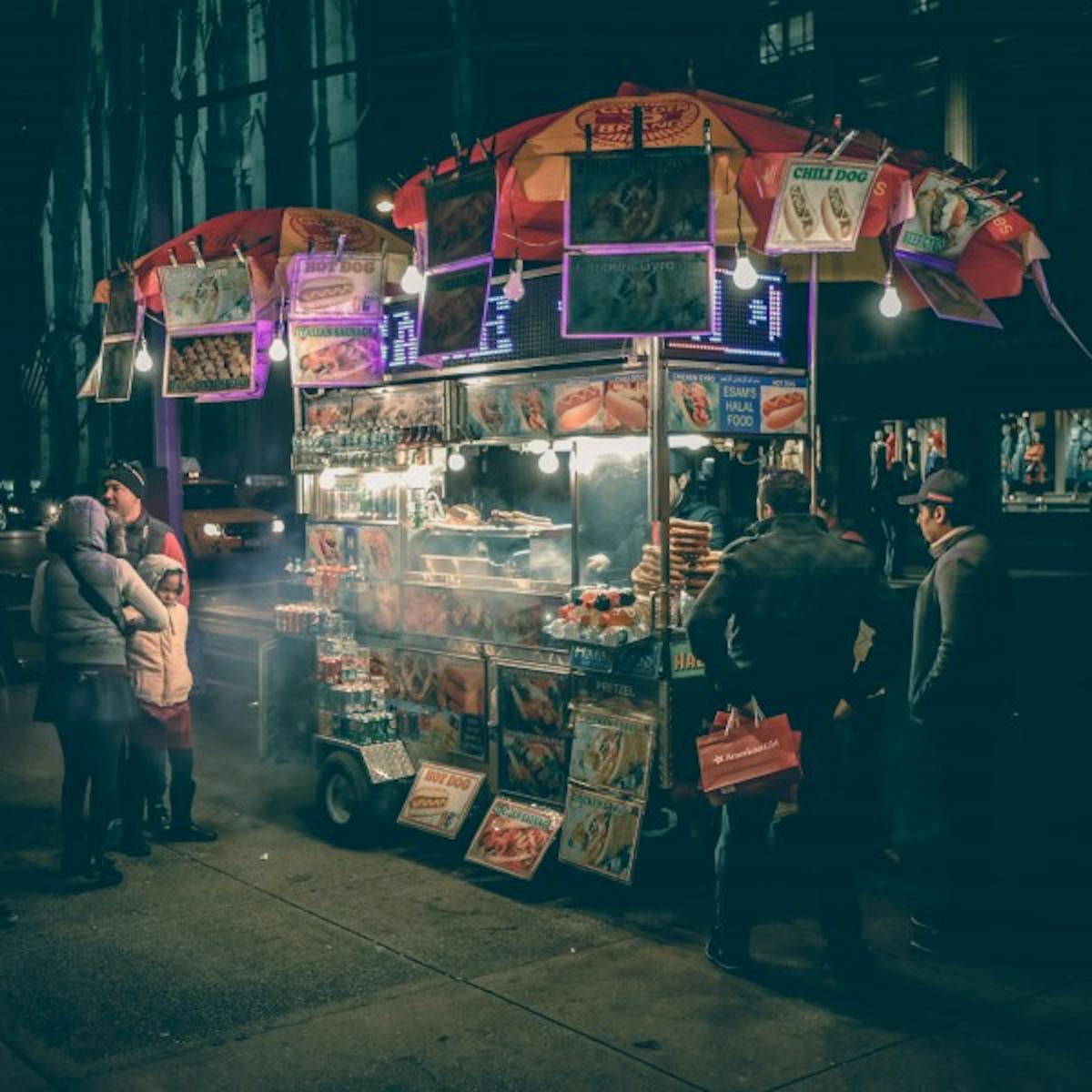 a group of people standing outside of a store