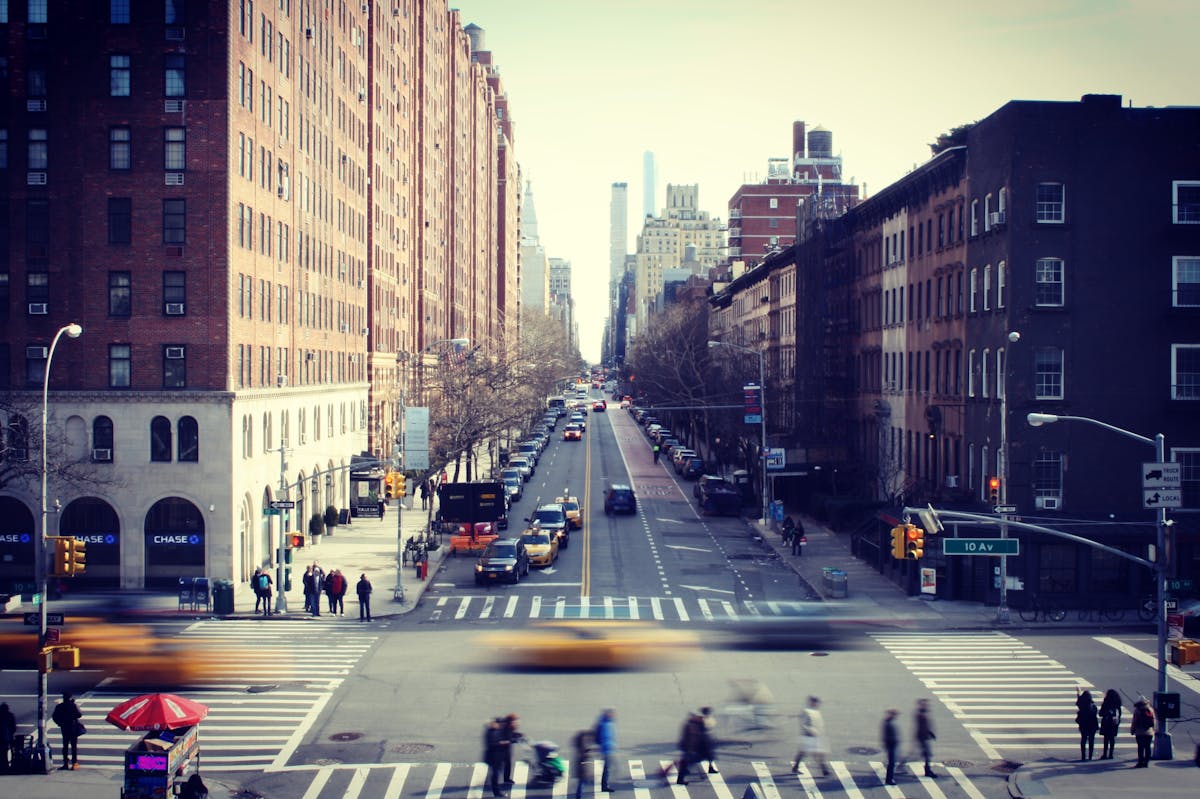 a group of people walking down a busy city street