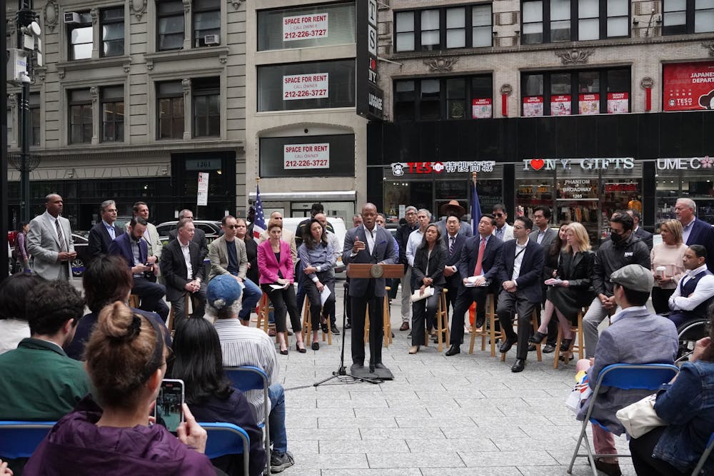a group of people walking down the street in front of a crowd