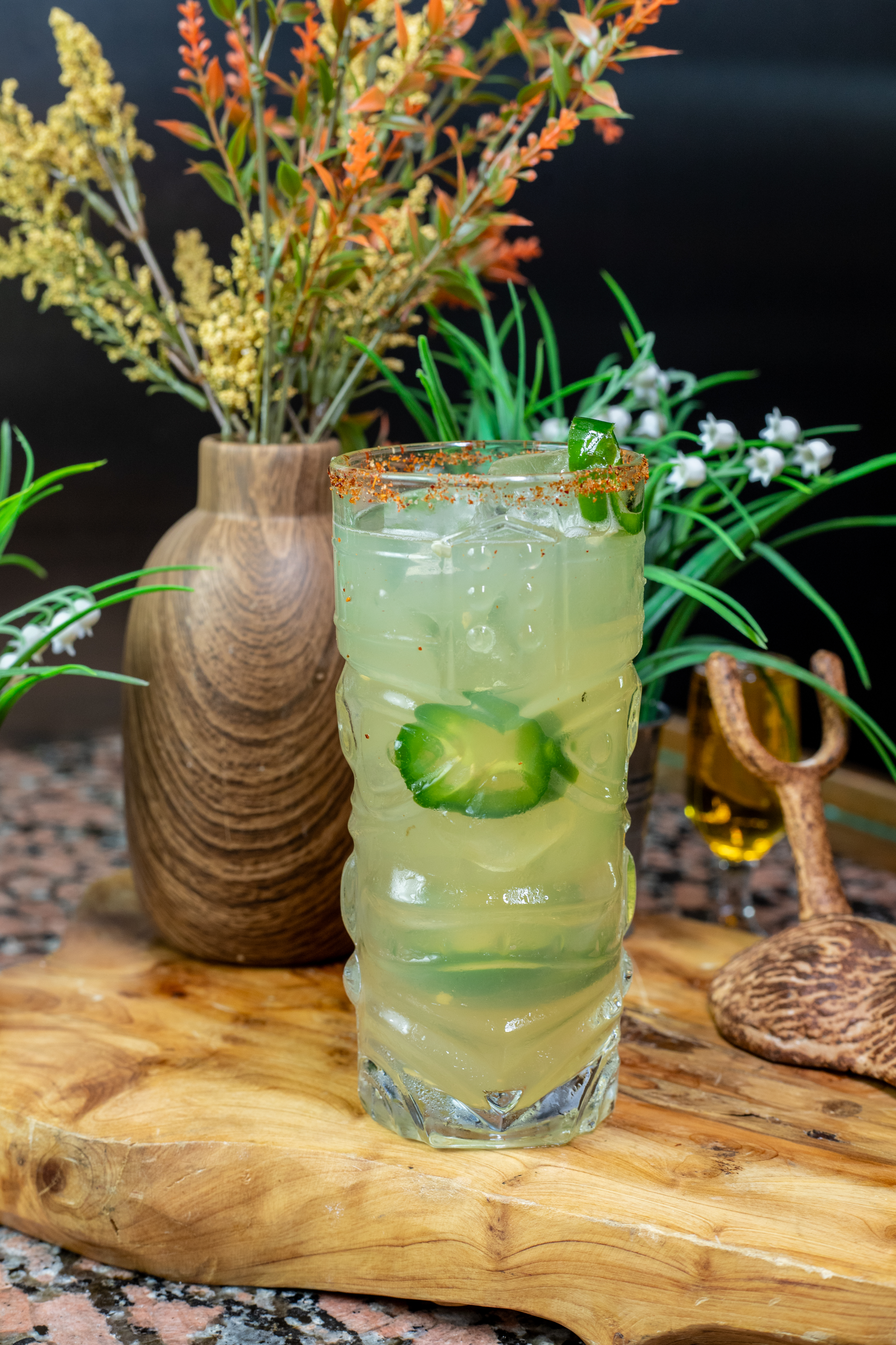 a vase of flowers sitting on top of a wooden table