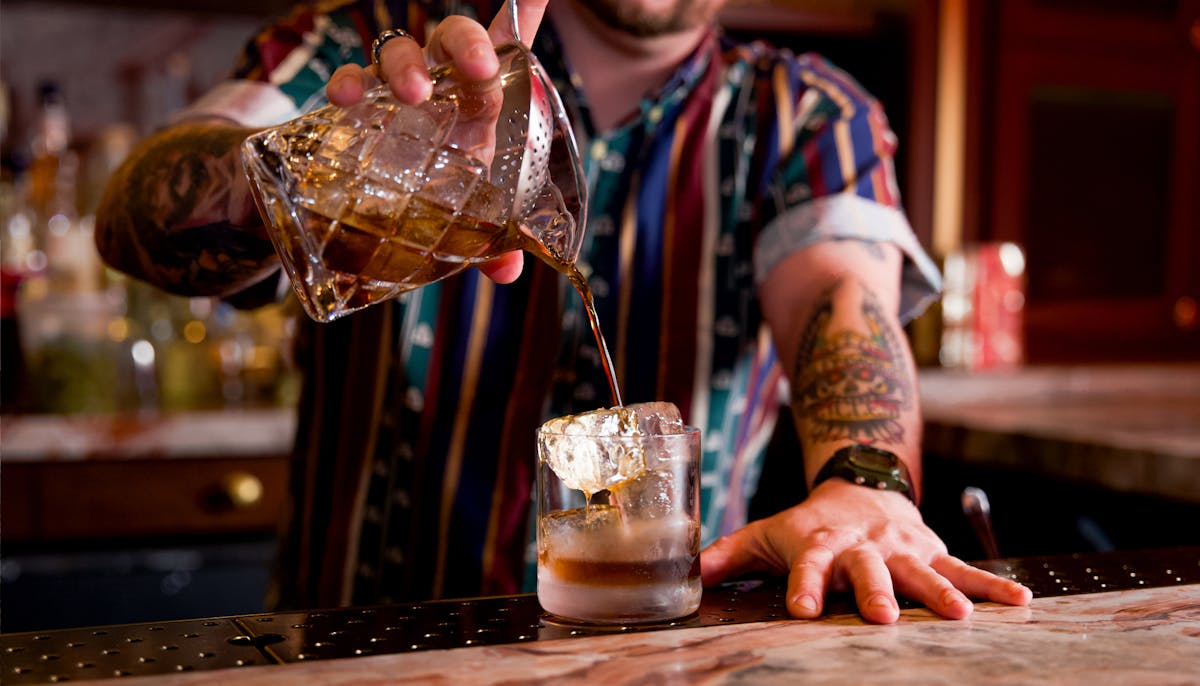 a bartender pouring a drink