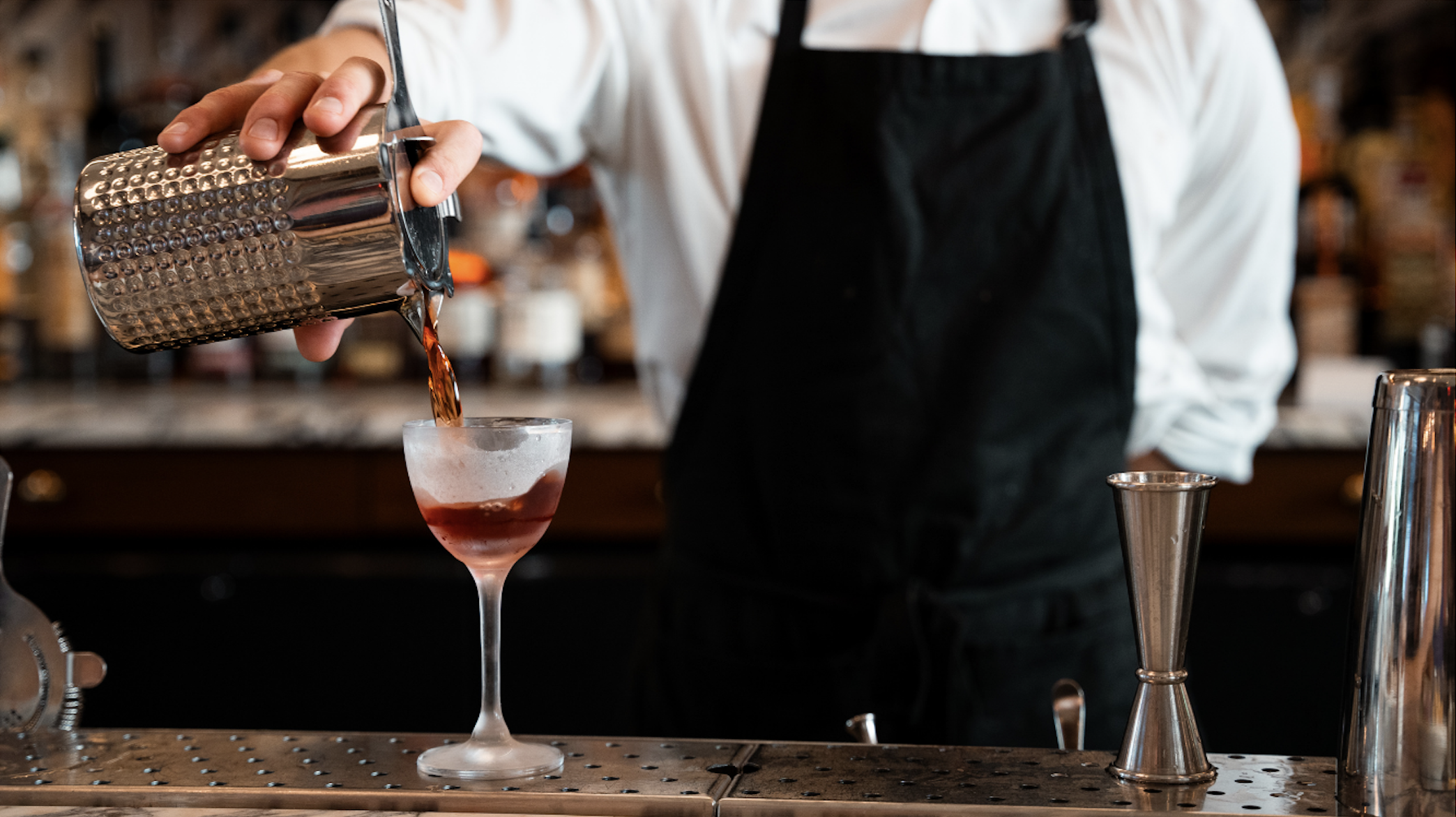 a person sitting at a table with wine glasses
