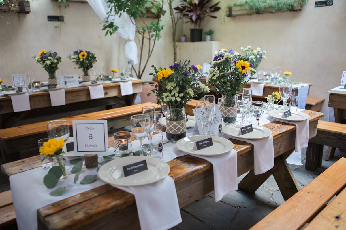 a room filled with furniture and vase of flowers on a table