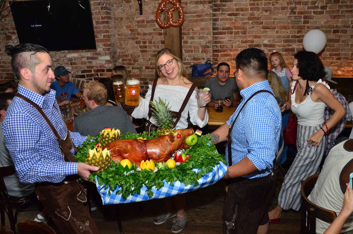 a group of people sitting at a table with food