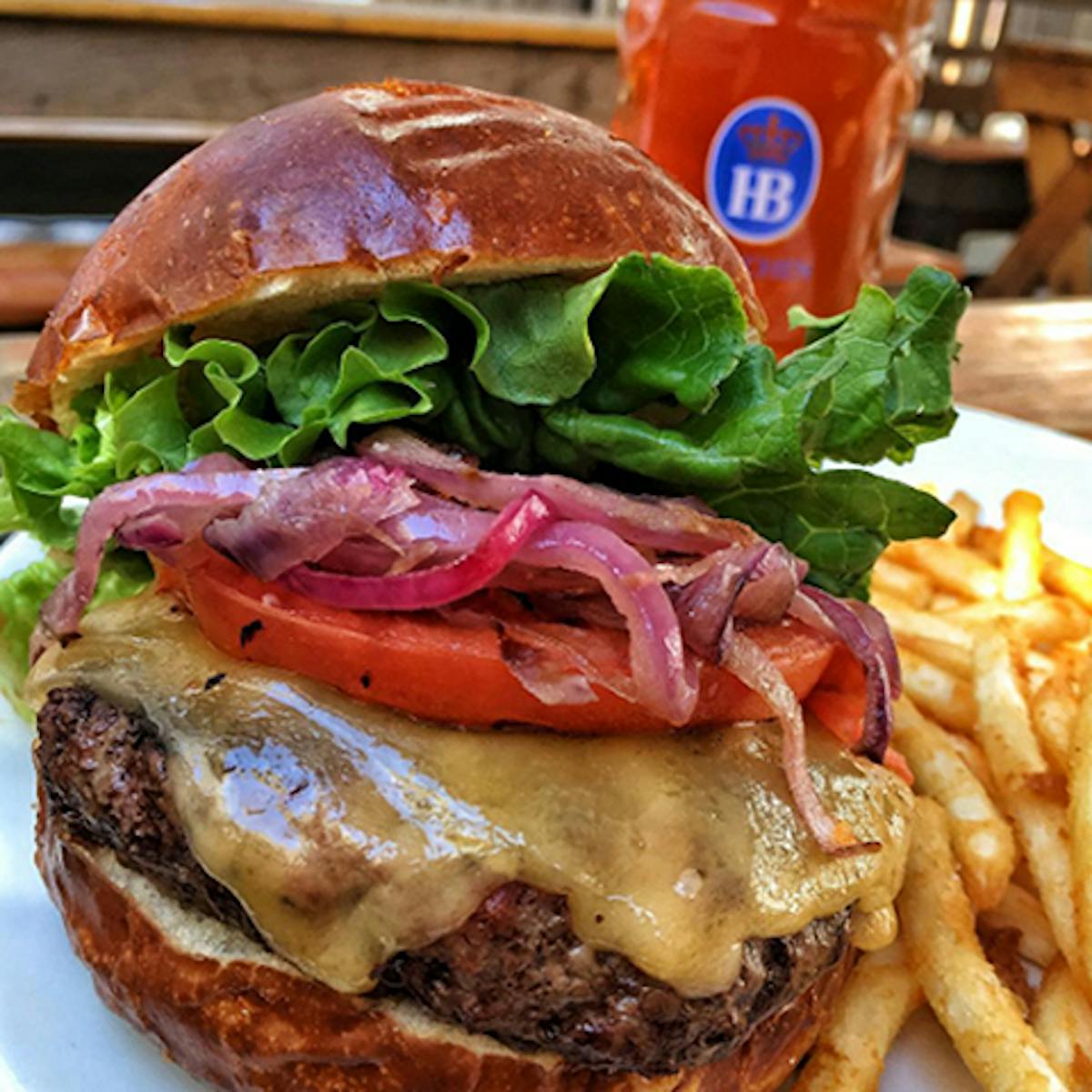 a large sandwich sitting on top of a pile of fries