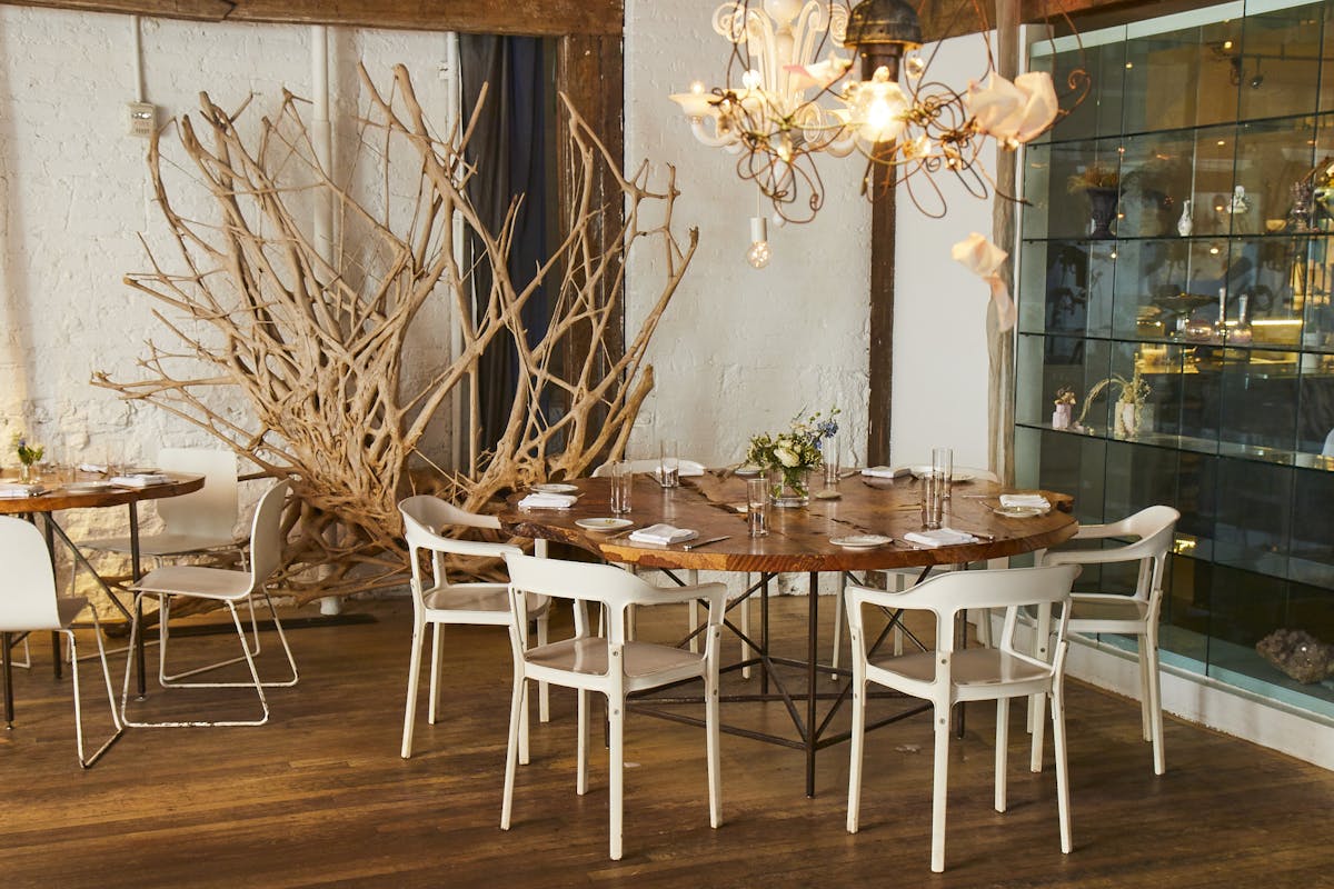 a close up look to a brown table with white chairs