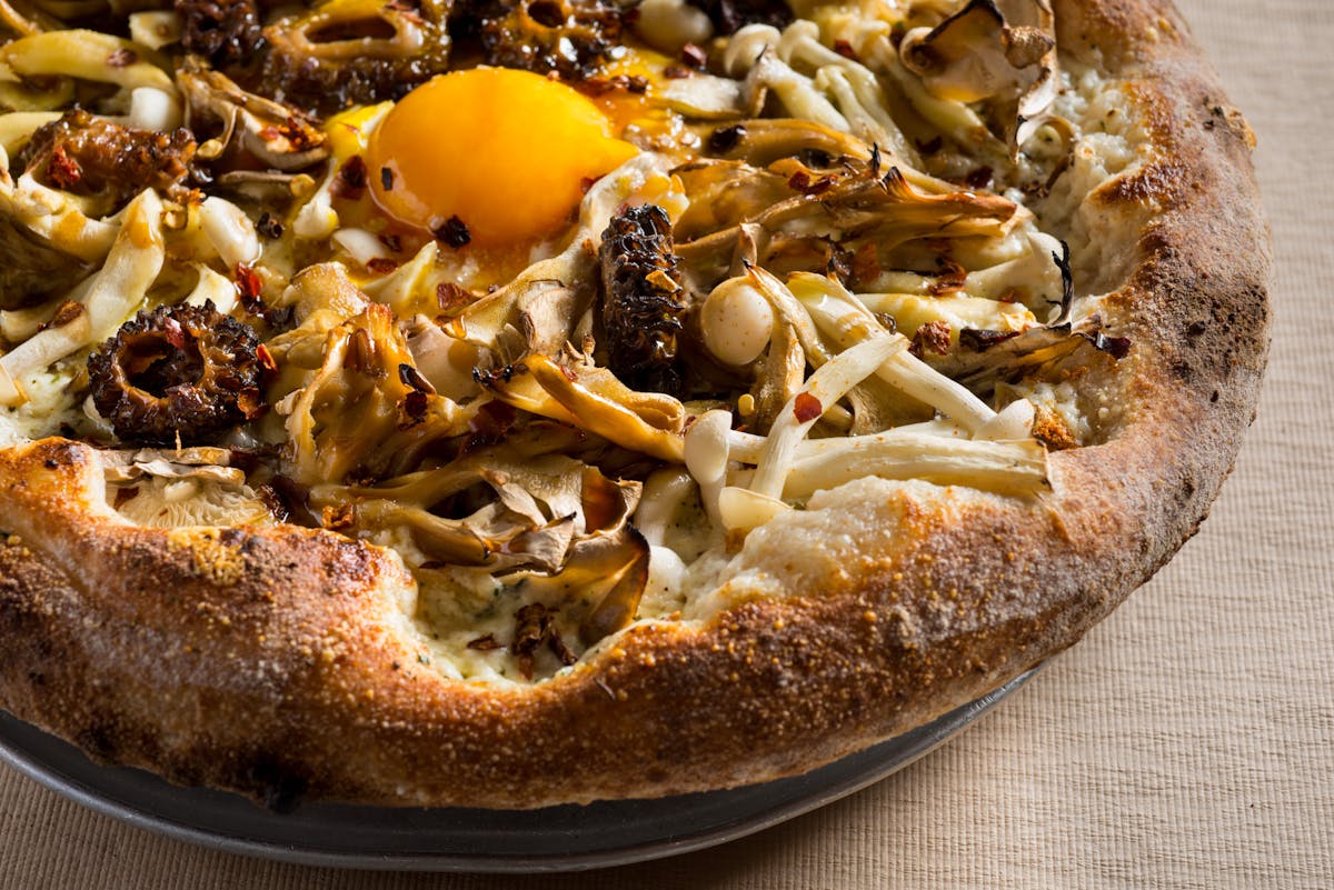 a pizza sitting on top of a plate of food
