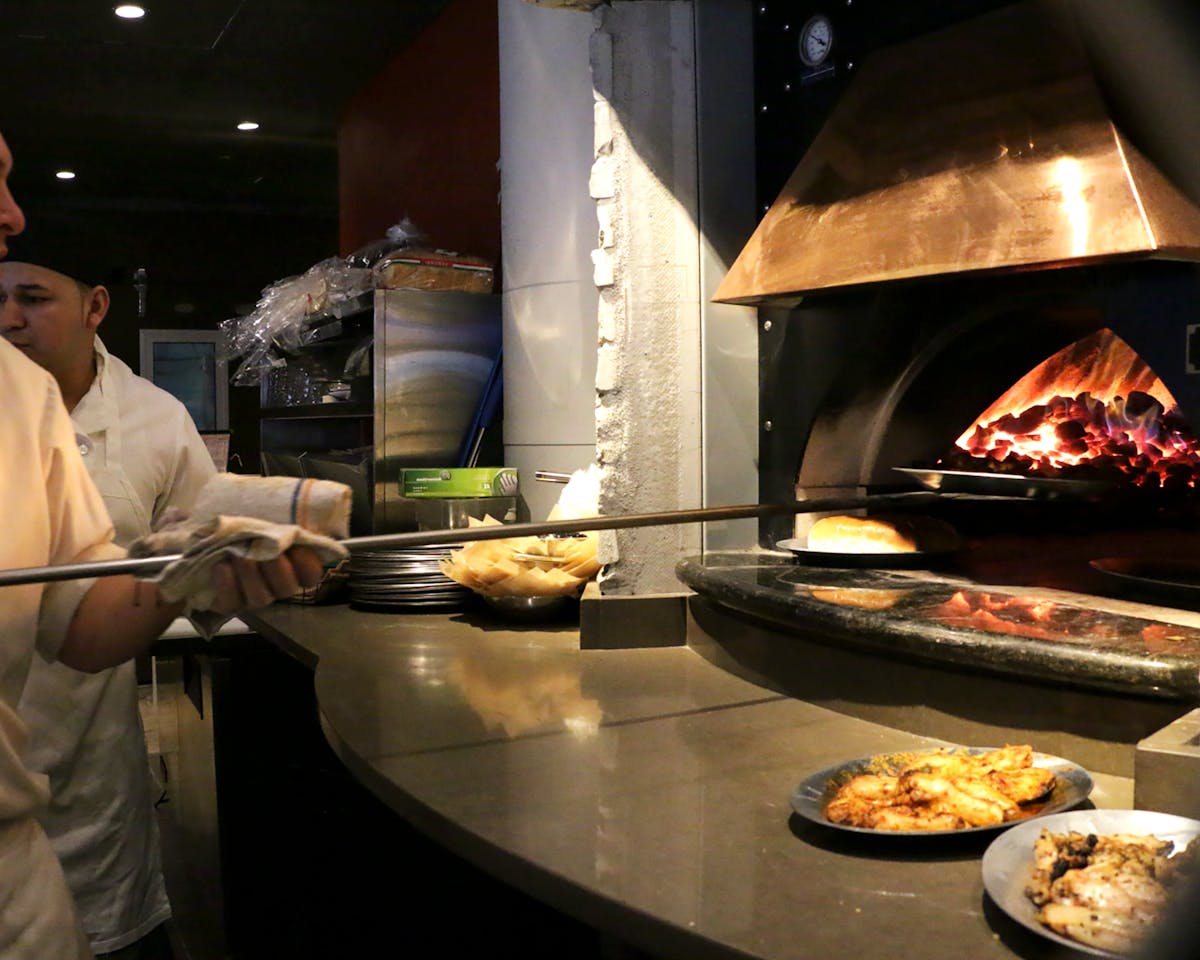 a person cooking pizza