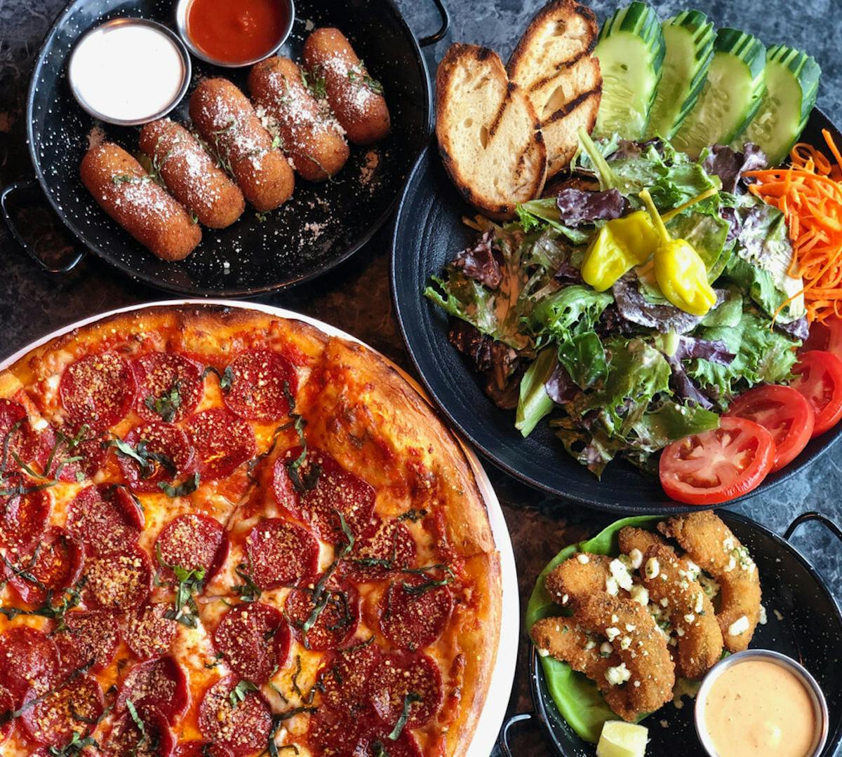 a pizza sitting on top of a plate of food