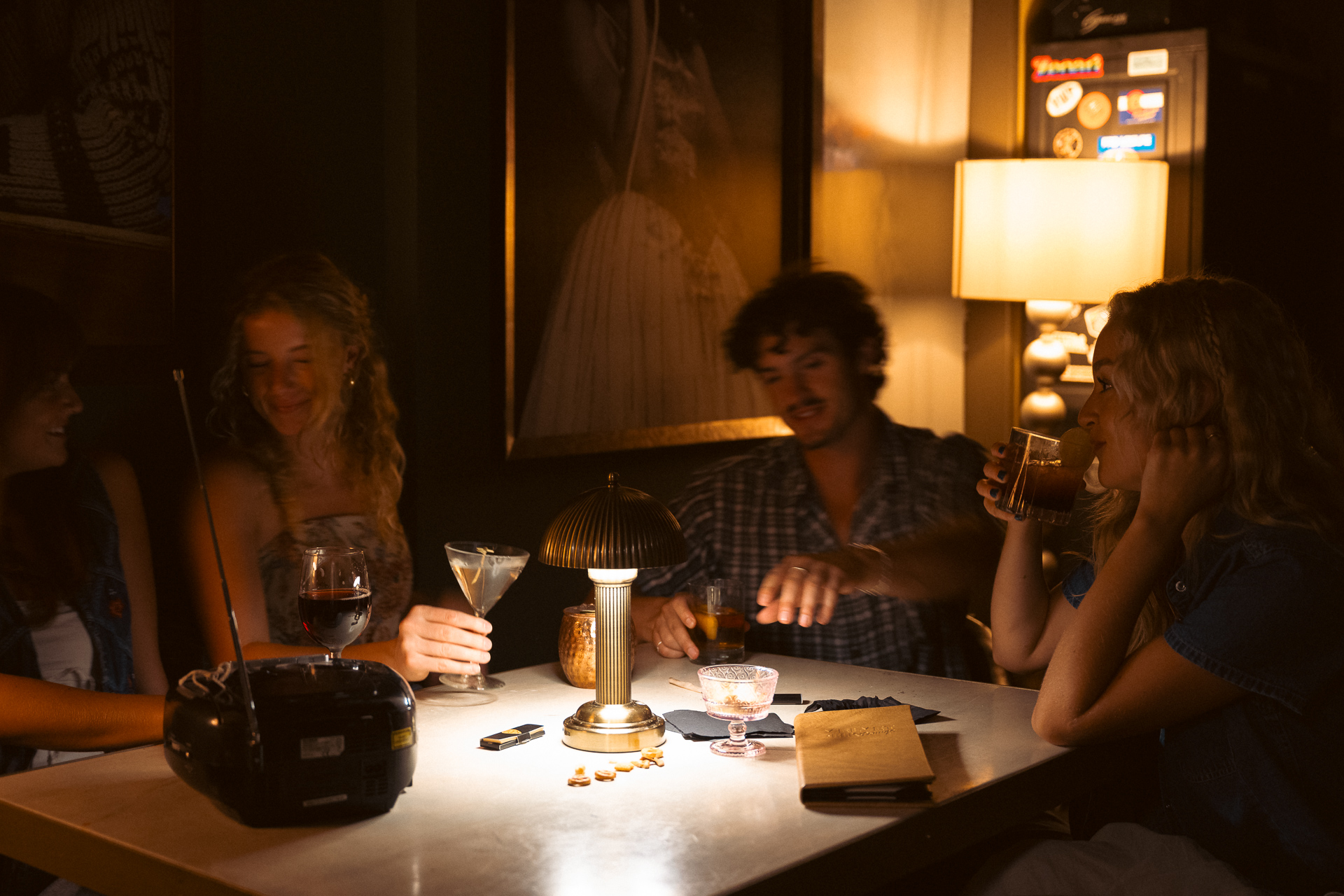 a person sitting at a table with wine glasses