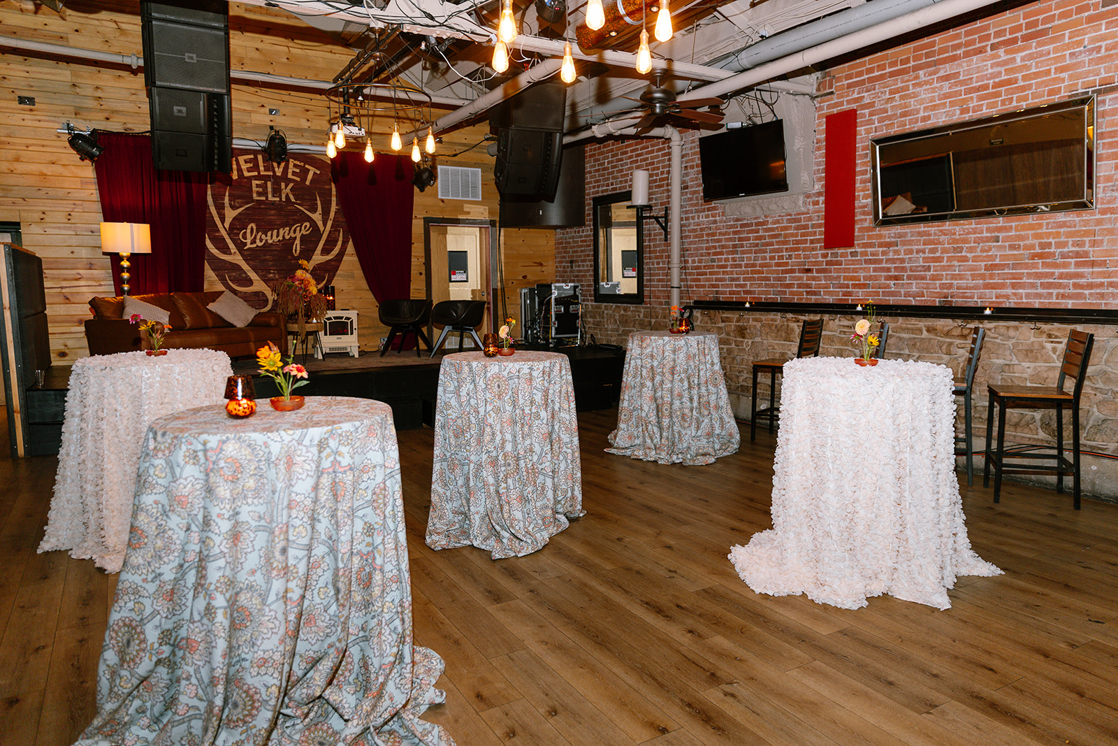 a room with tables covered in cloths