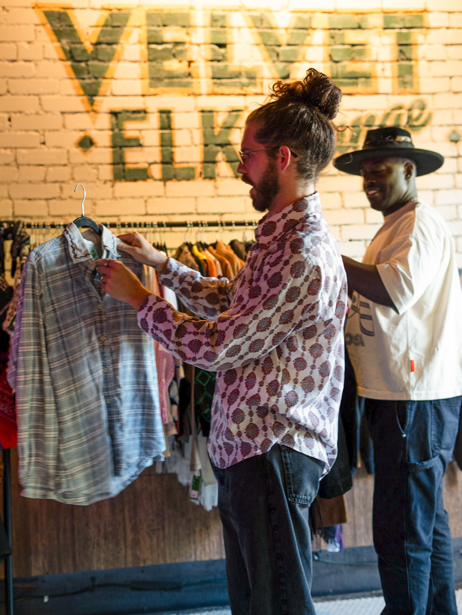 a man and a woman standing in front of a building