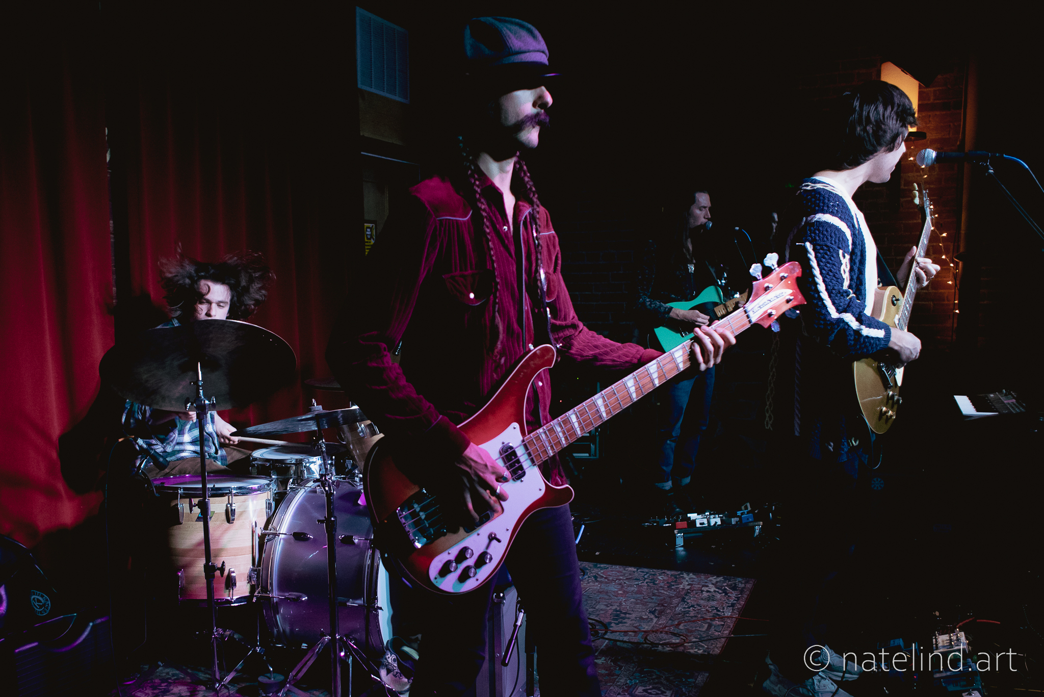a man standing on a stage playing instruments