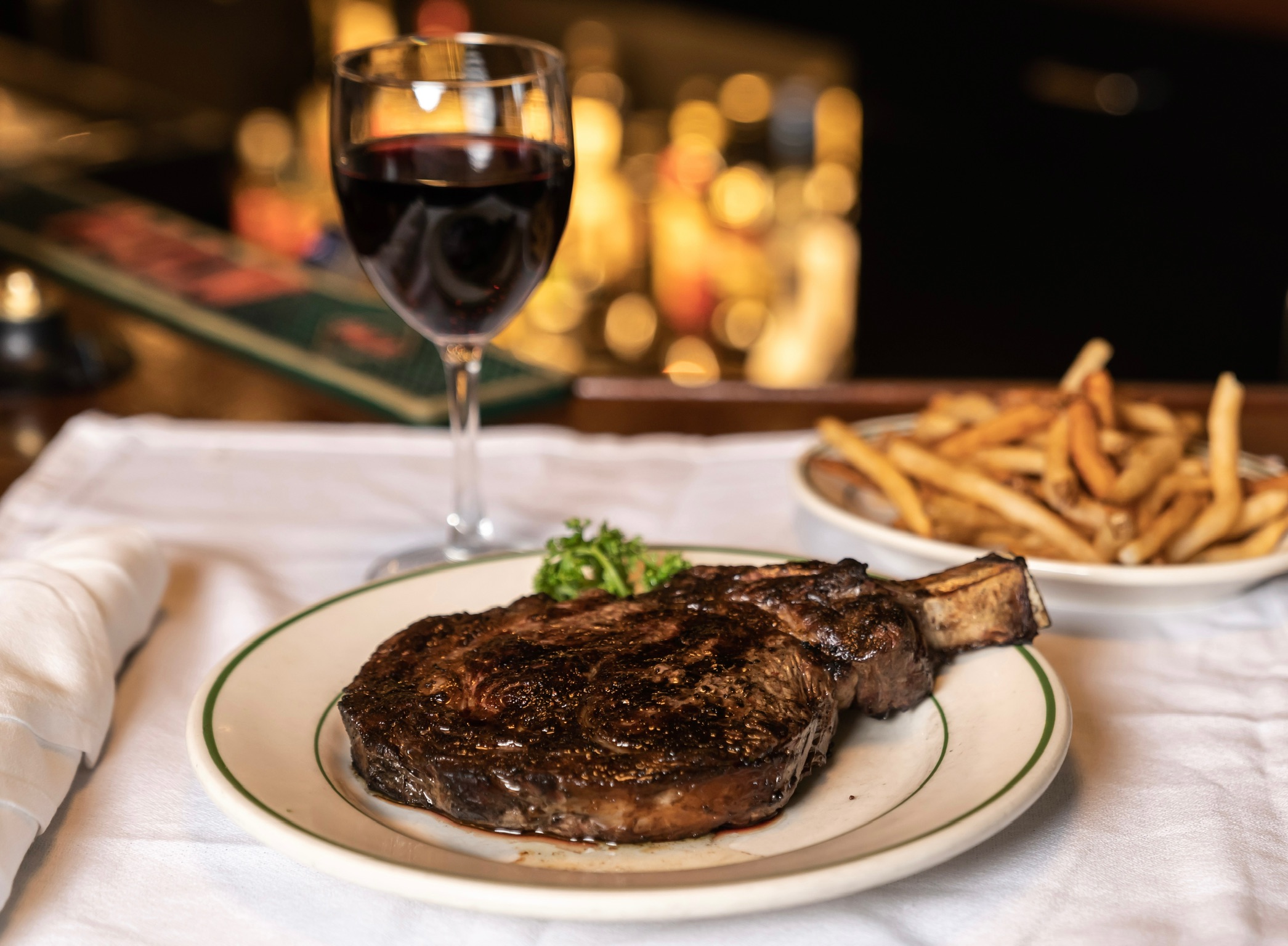 a close up of a plate of food and a glass of wine