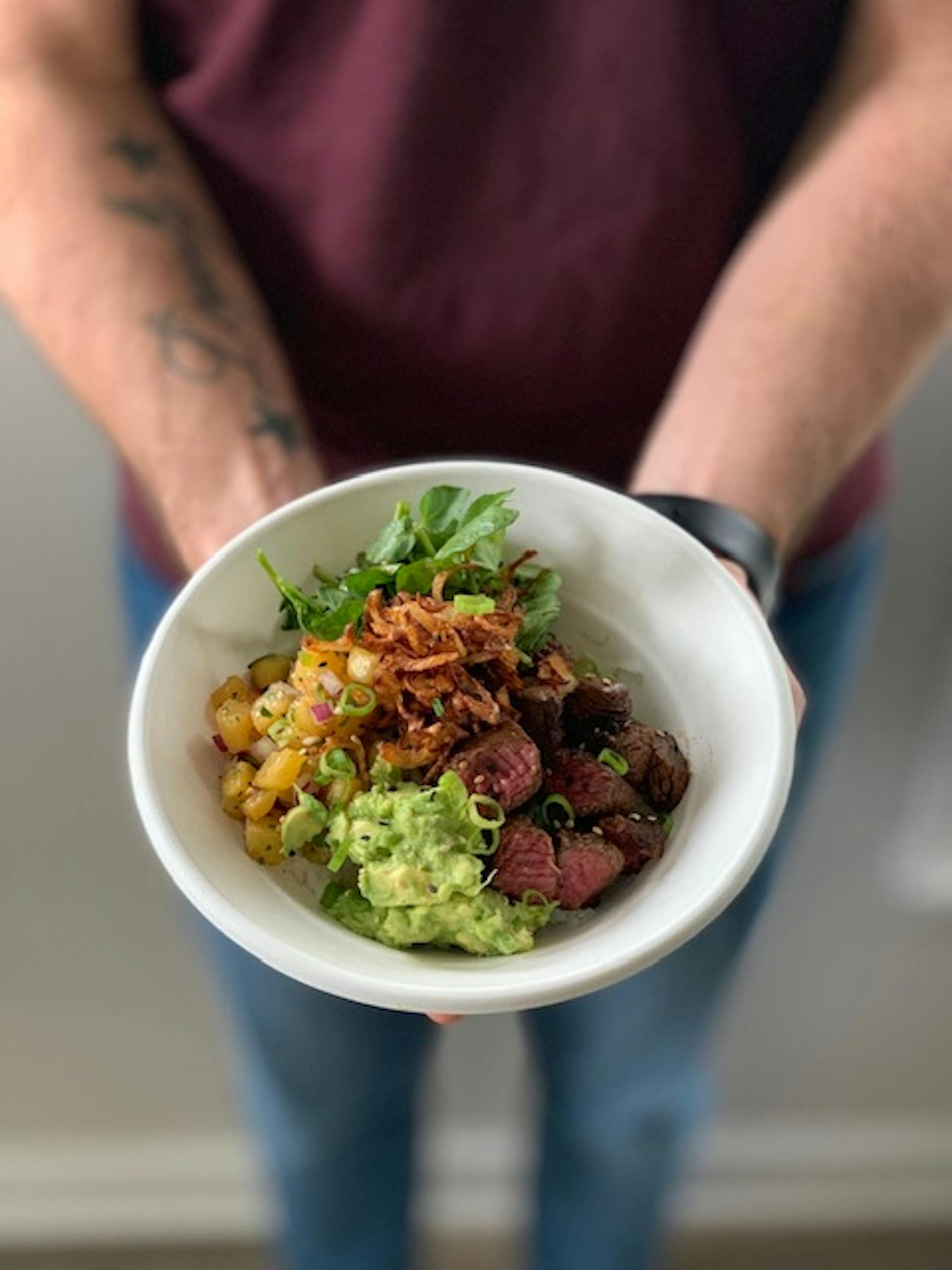 a person holding a bowl of food