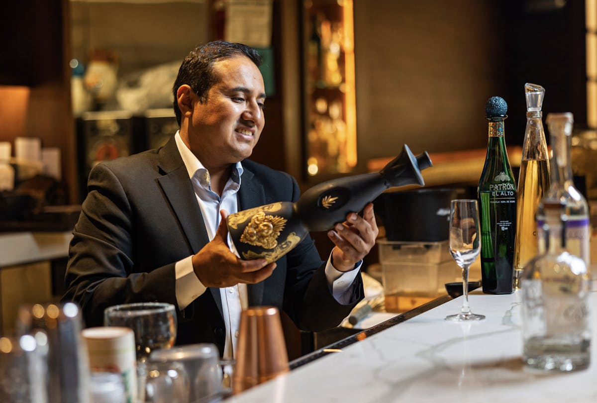 a person sitting at a table with wine glasses
