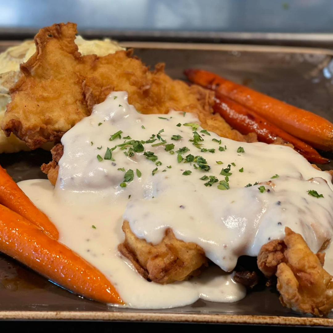 a plate of food with meat and vegetables