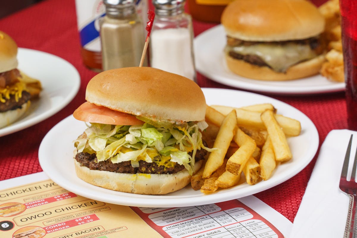 a table topped with a sandwich and fries on a plate