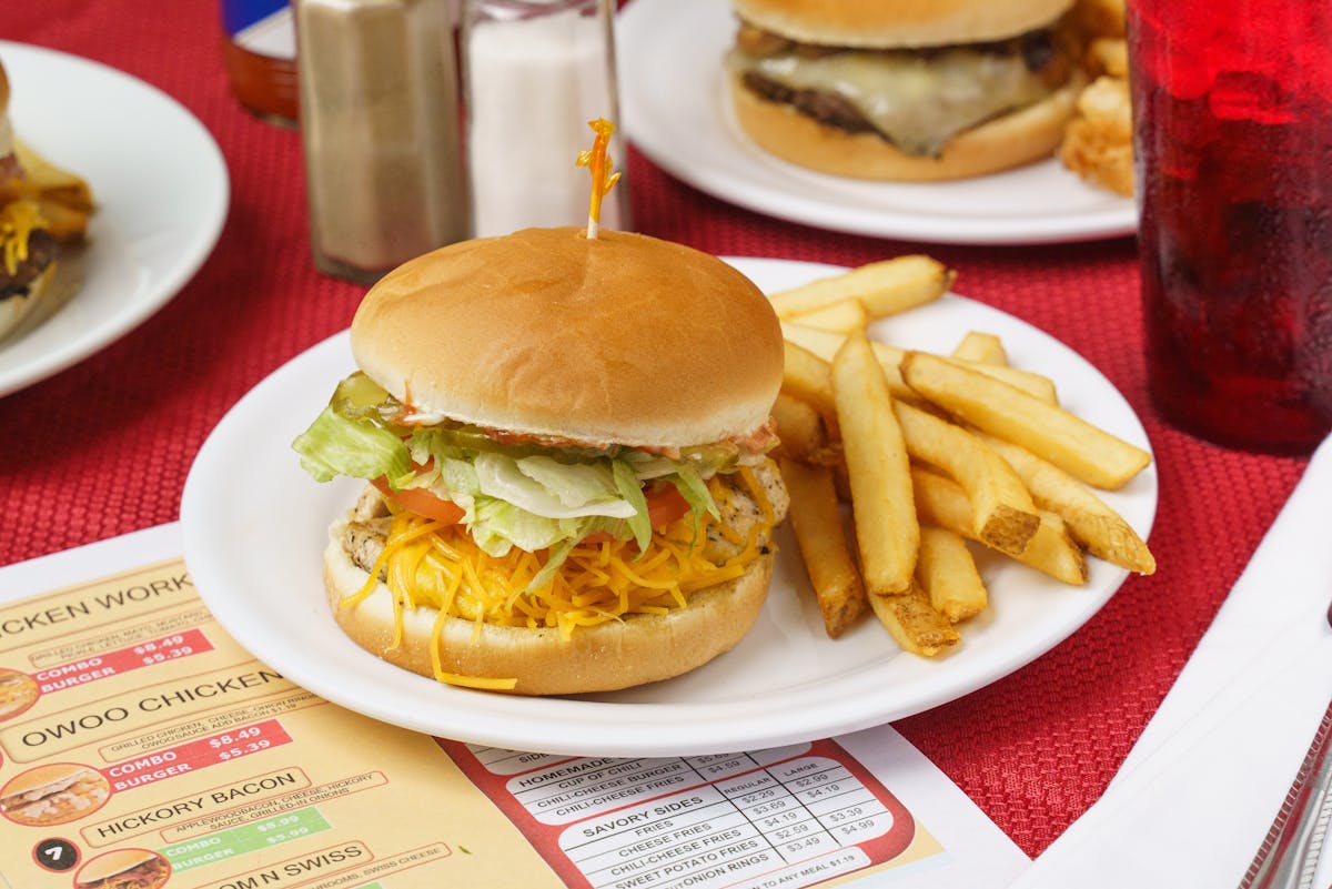 a table topped with a sandwich and fries on a plate