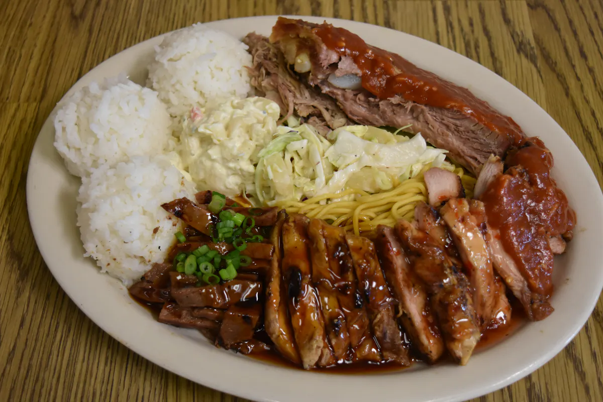 a plate of food with rice meat and vegetables