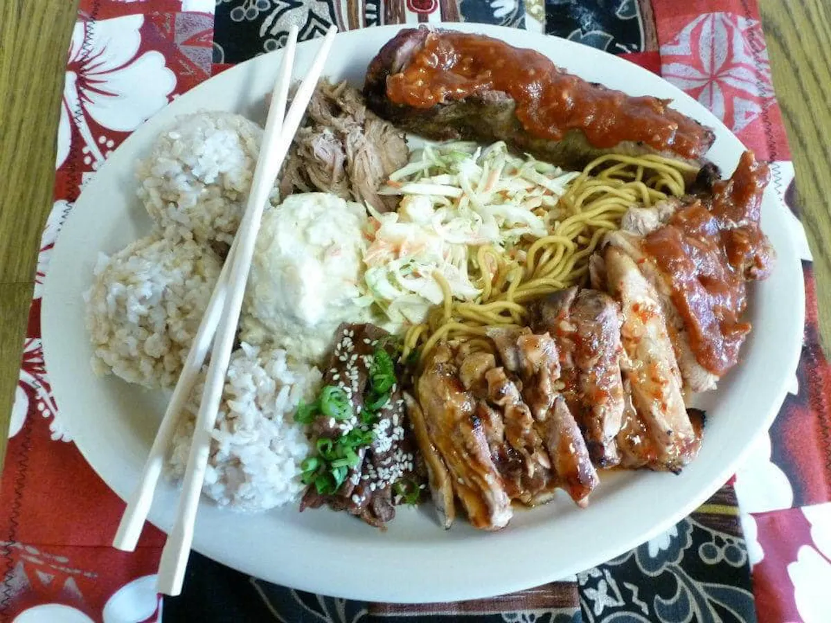 a plate of food with rice meat and vegetables