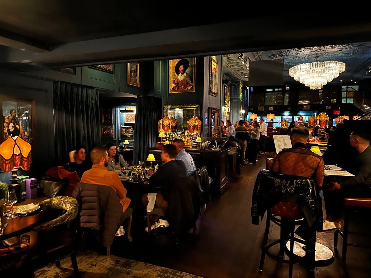 a group of people sitting at tables in a restaurant