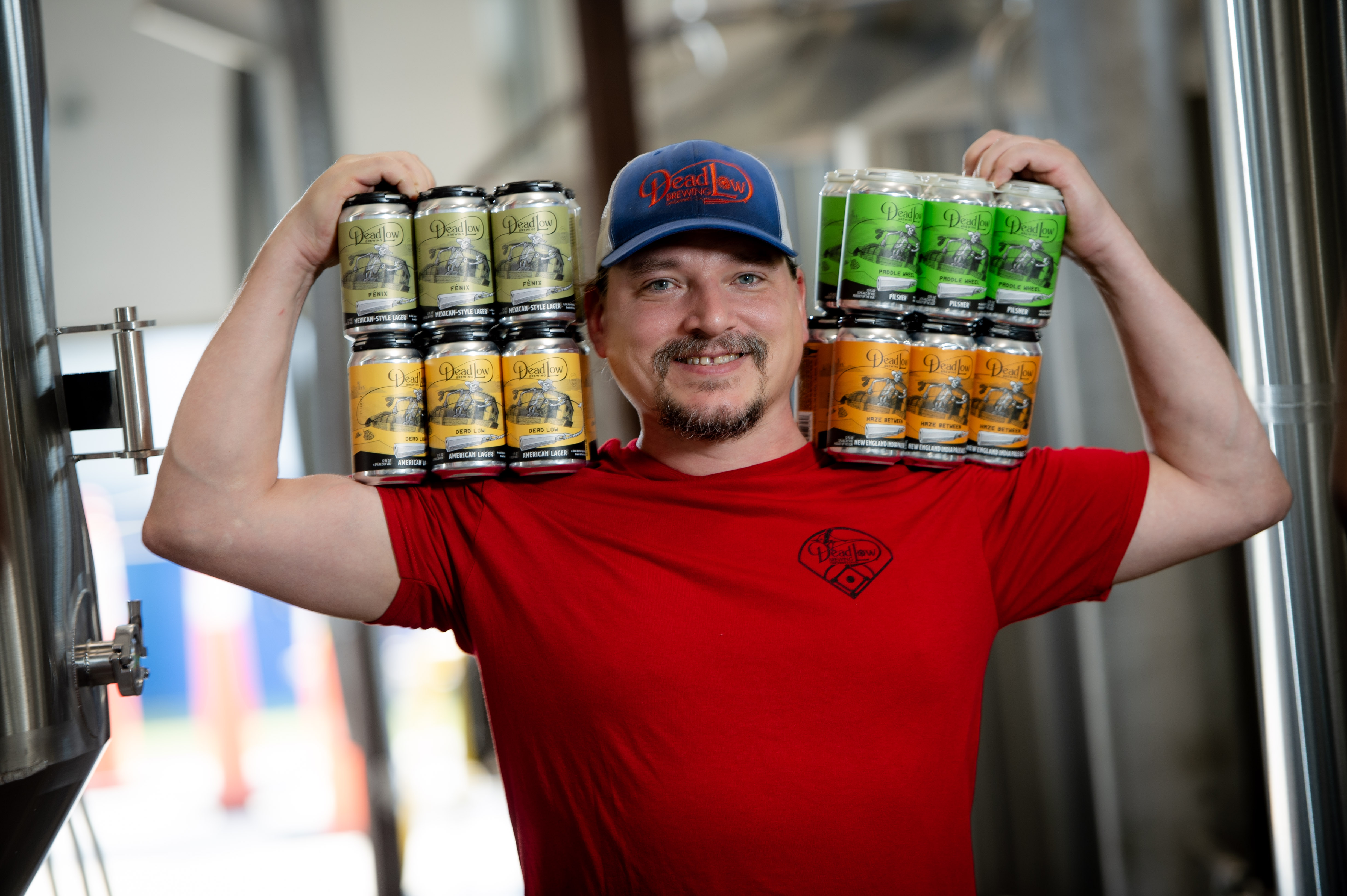 a man holding a glass of beer