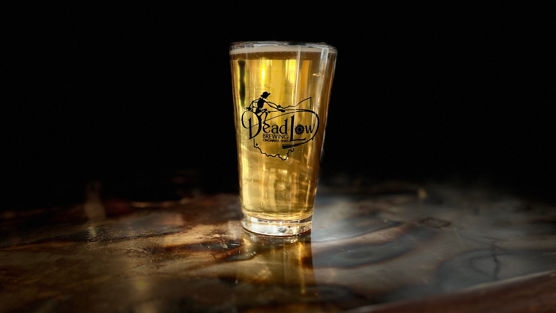 a glass of beer on a table
