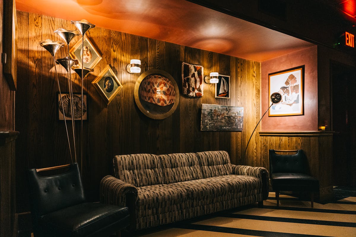 A cozy, dimly lit bar with high stools lined