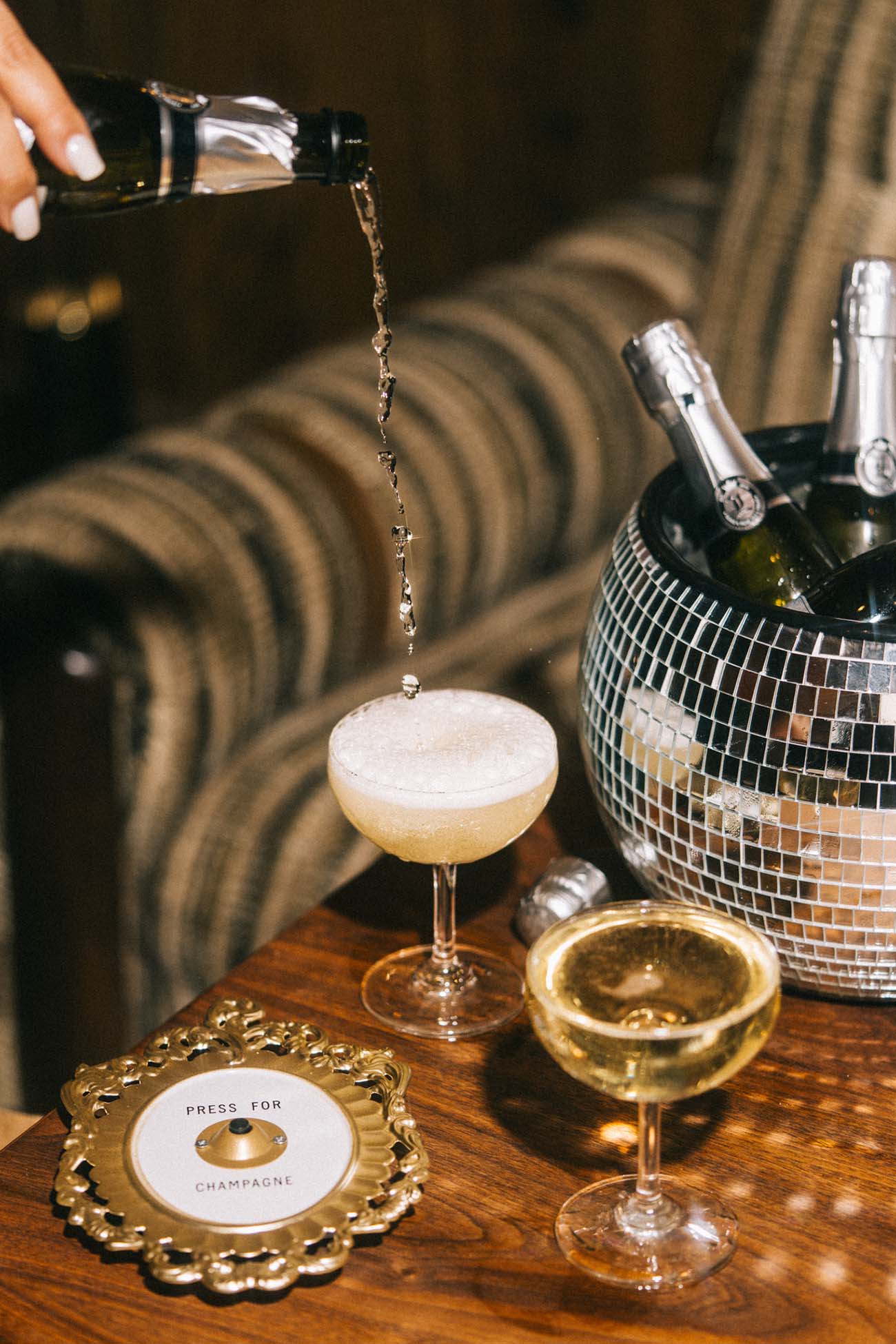 prosecco pouring into a glass on a table